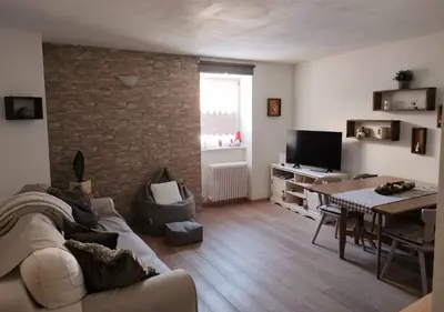 a living room with a couch and a table at Alessandro's Home in Carano