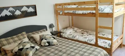 a bedroom with two bunk beds and a ladder at Alessandro's Home in Carano