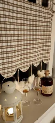 a table with two glasses and a bottle of wine at Alessandro's Home in Carano