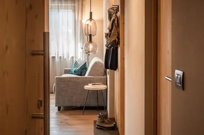 a living room with a couch and a table at Small Luxury Apartments Lausa in Valdaora