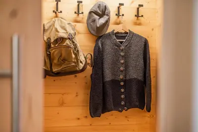 a jacket and a purse are hanging on a closet at Small Luxury Apartments Lausa in Valdaora