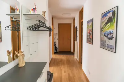 a room with white walls and a hallway at Luxus Penthouse mit Terrasse, Garage, Fahrradraum und Infrarotsauna in Merano