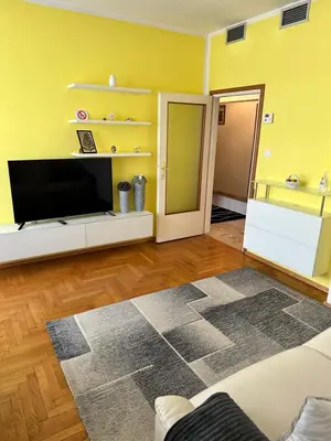 a bedroom with a bed and a wooden floor at Appartamento Vacanze in Merano