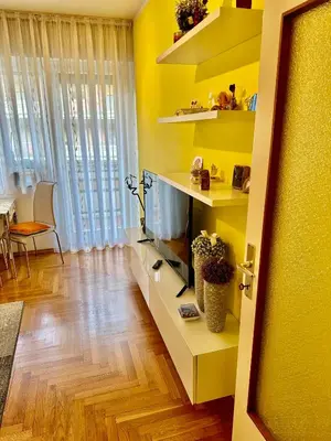 a living room with a flat screen tv and a couch at Appartamento Vacanze in Merano