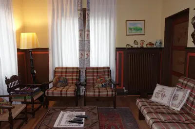 a living room with two chairs and a couch at Villa Molteni, Ville di Fiemme, Varena in Varena