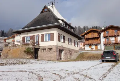 a house with a car parked in front of it at Villa Molteni, Ville di Fiemme, Varena in Varena
