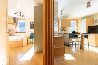 a room with a kitchen and a dining room at Cesa Antermoia in Mazzin