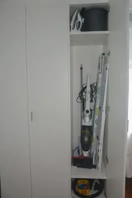 a white cabinet filled with lots of tools at moderne Ferienwohnung in Merano