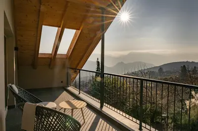 a balcony with chairs and a view of the mountains at San Antonia in Caldaro