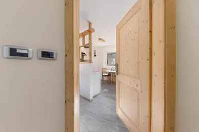 a hallway with a door leading to a kitchen at CASA PARE' B&B in Tesero