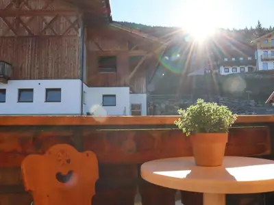 a table with a potted plant on top of a building at Portnerhof auf Oberkirn in Schenna