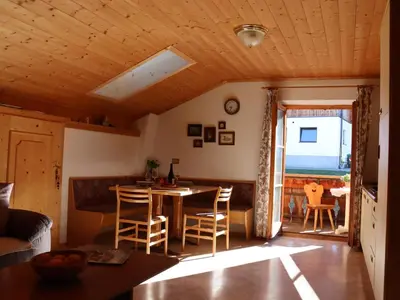 a kitchen and living room with a table and chairs at Portnerhof auf Oberkirn in Schenna