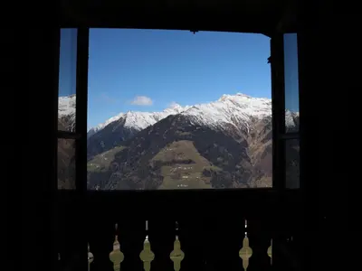 a view of a mountain through a window at Portnerhof auf Oberkirn in Schenna
