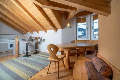 a room with a wooden table and a desk at Ciasa Gianot - Shin in Moena