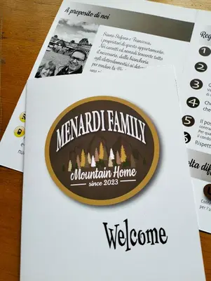 a sign for a mansard familyowment home on a newspaper at Deliziosa mansarda con vista Dolomiti in San Vito di Cadore