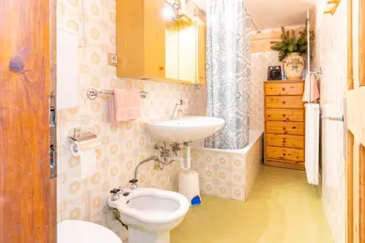 a bathroom with a toilet and a sink at Salmsein Biohof in Fiè