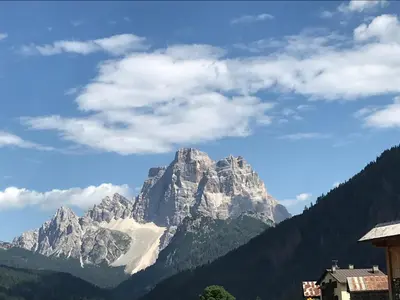 a view of a large mountain in the distance at Dolomia in Villagrande