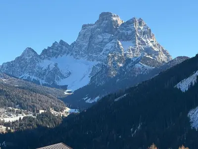 a view of a mountain with trees and snow at Dolomia in Villagrande