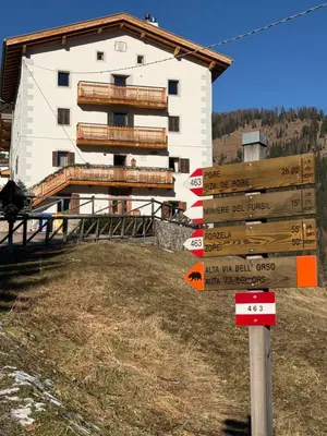 a building with a bunch of signs in front of it at Dolomia in Villagrande