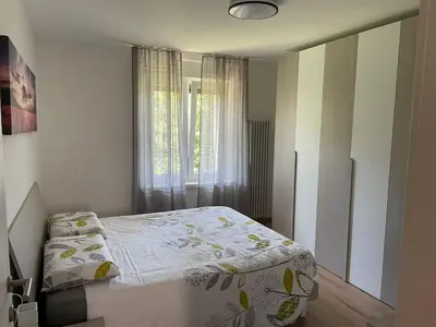 a small bedroom with a bed and a window at Apartment LUNA in Tesero