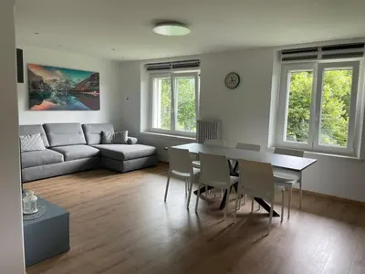 a living room with a table and a couch at Apartment LUNA in Tesero