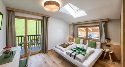 a bedroom with a bed and a large window at Hoferhof in Maranza