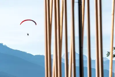 a kite is flying in the sky through a window at Hoferhof in Maranza