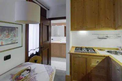 a kitchen with a sink and a stove top oven at Sweet Cristallo in Cortina dʼAmpezzo