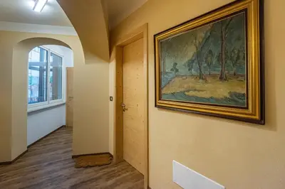 a painting hanging on a wall in a hallway at DolomiApartments - Appartamenti Campanil 1 e Campanil 2 in Predazzo