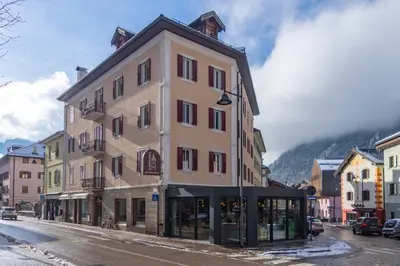 a building on the side of a street at DolomiApartments - Appartamenti Campanil 1 e Campanil 2 in Predazzo