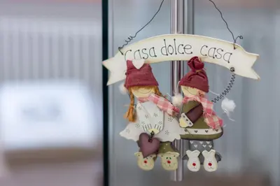 twoidaida dolls hanging from a sign that reads lost dixie cast at DolomiApartments - Appartamento Orso Bruno in Predazzo