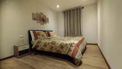 a small bedroom with a bed and a night stand at In centro col giardino in Predazzo