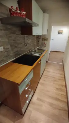 a kitchen with a sink and a counter top at In centro col giardino in Predazzo