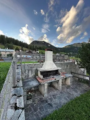 a stone fireplace sitting on top of a stone wall at Tabia Suite Pelmo in Villagrande