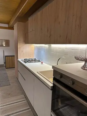 a kitchen with a stove and a counter top at Tabia Suite Pelmo in Villagrande
