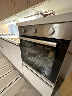 a kitchen with an oven in a kitchen at Tabia Suite Pelmo in Villagrande