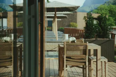 a table and chairs on a patio with an umbrella at Solterra Poolhouse 1 in Tesimo