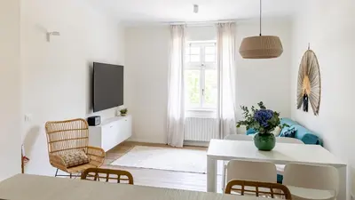 a white living room with a white table and chairs at Italyescapes Emma 22 in Merano