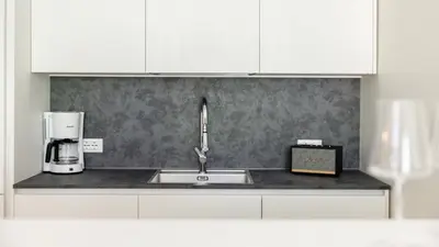 a kitchen counter with a sink and a coffee maker at Italyescapes Emma 22 in Merano