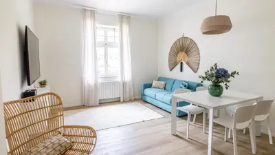 a living room with a blue couch and a table at Italyescapes Emma 22 in Merano