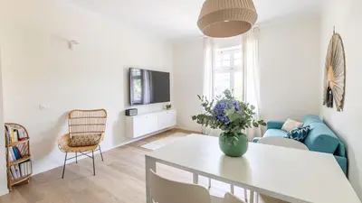 a living room with a vase of flowers on a table at Italyescapes Emma 22 in Merano