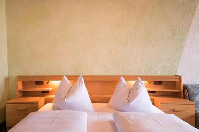 a bedroom with two beds with white pillows at Gästehaus Marianne Terenten in Terento