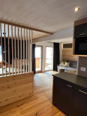 a large living room with a kitchen and a living room at Lüch dl Finatzer in San Martino in Badia