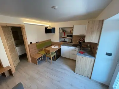 a small kitchen with a table and a counter top at Neuhäusl-Hof in San Genesio Atesino