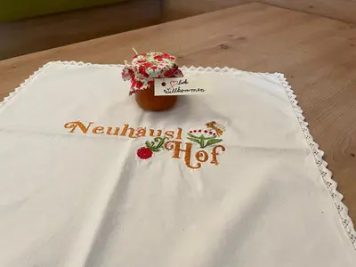 a white napkin with a cake on a table at Neuhäusl-Hof in San Genesio Atesino