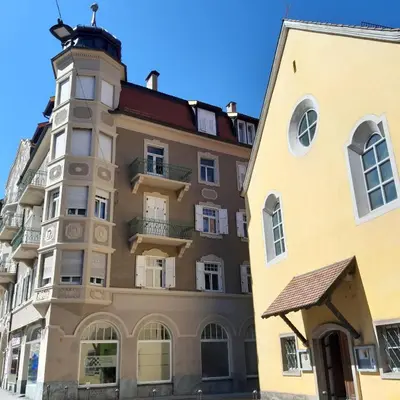 an apartment building with a turret at Meranosuites in Merano