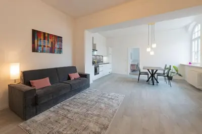 a living room with a couch and a table at Meranosuites in Merano
