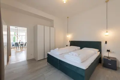 a bedroom with a large bed with white pillows at Meranosuites in Merano