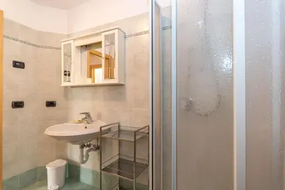 a bathroom with a sink and a shower at Casa Freina in Vigo di Fassa