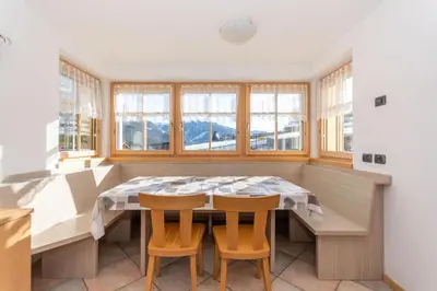 a dining room with a table and two chairs at Casa Freina in Vigo di Fassa